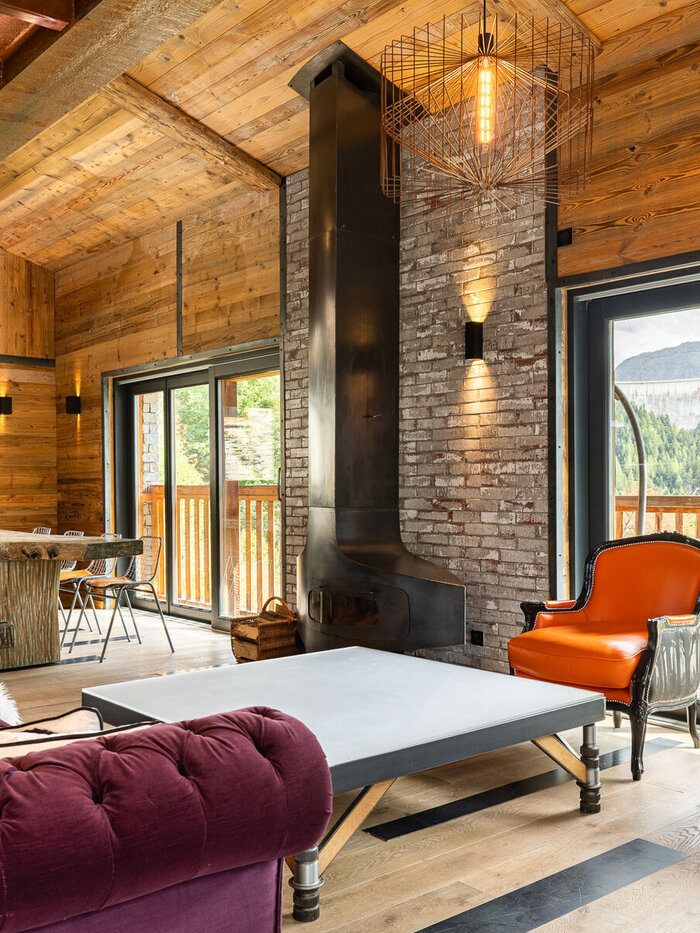 Chalet Gallery's lounge in Tignes, with a wood-burning stove and street art on the walls
