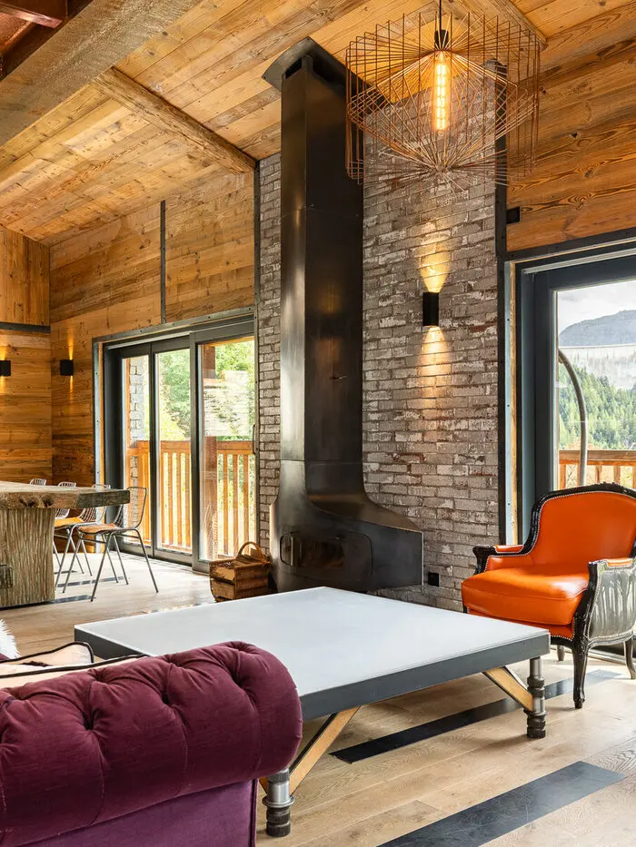 Chalet Gallery's lounge in Tignes, with a wood-burning stove and street art on the walls