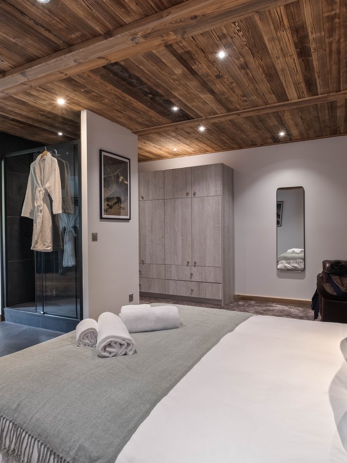 Zephyr's open-plan living and dining room in the OFF-PISTE Collection, Tignes, with mustard velvet sofas and aviation-themed artwork