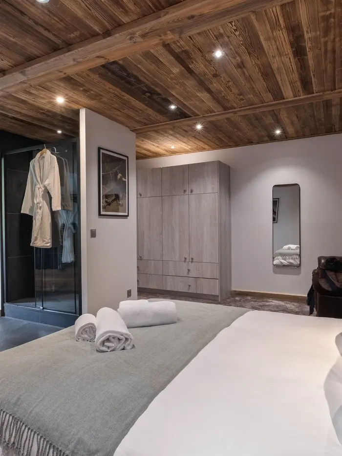 Zephyr's open-plan living and dining room in the OFF-PISTE Collection, Tignes, with mustard velvet sofas and aviation-themed artwork