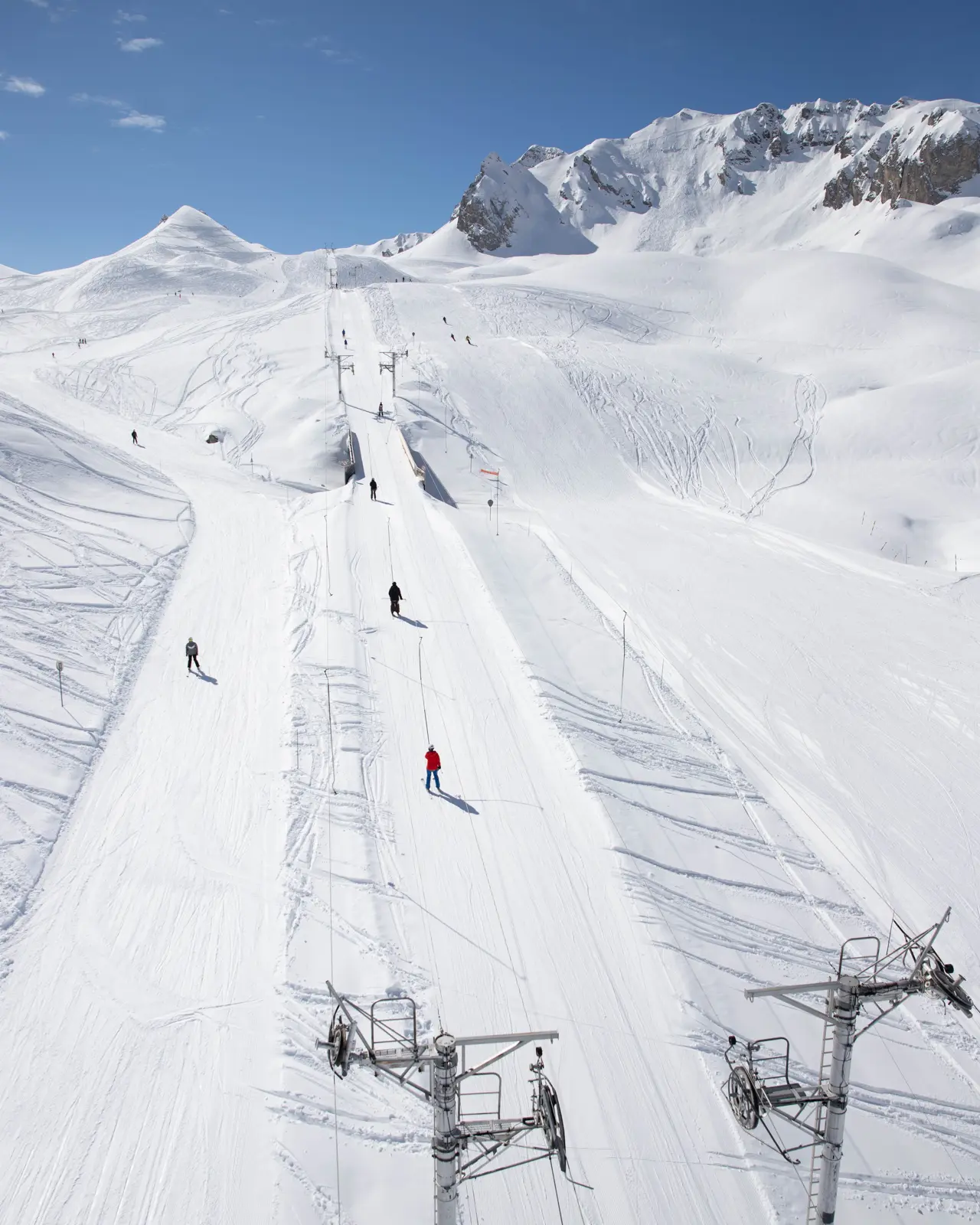 Skiers on a groomed run in Courchevel